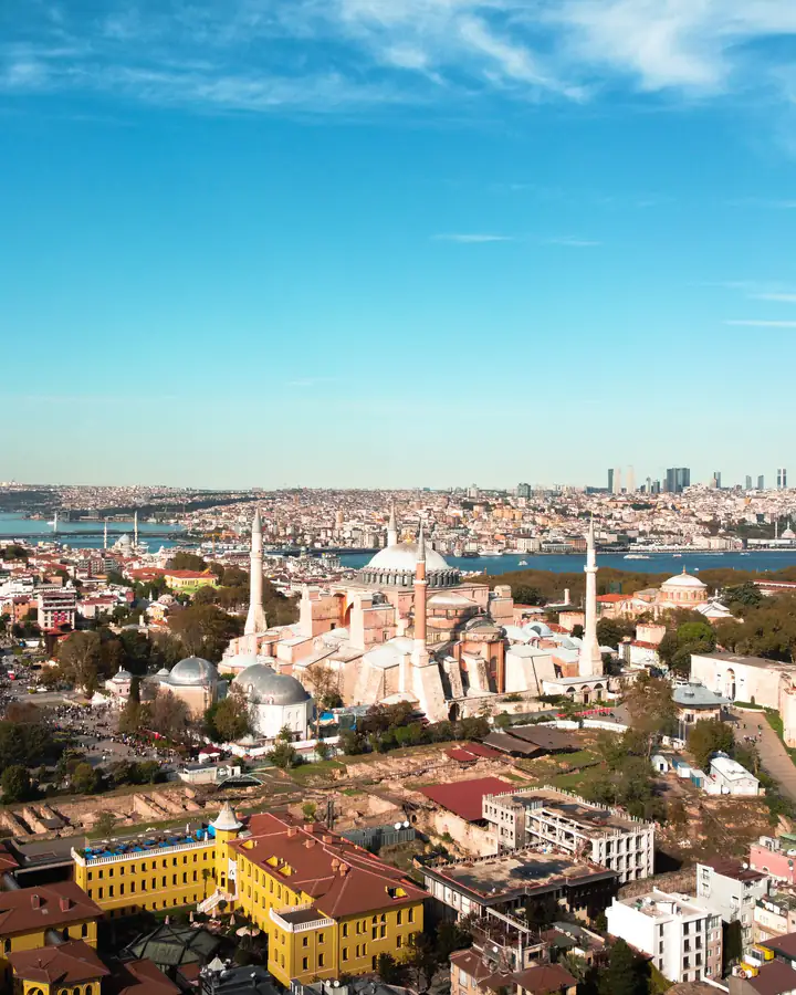 Istanbulul văzut de sus: Hagia Sofia, cu minaretele ei, orașul vechi și Bosforul în spate, sub cer albastru.